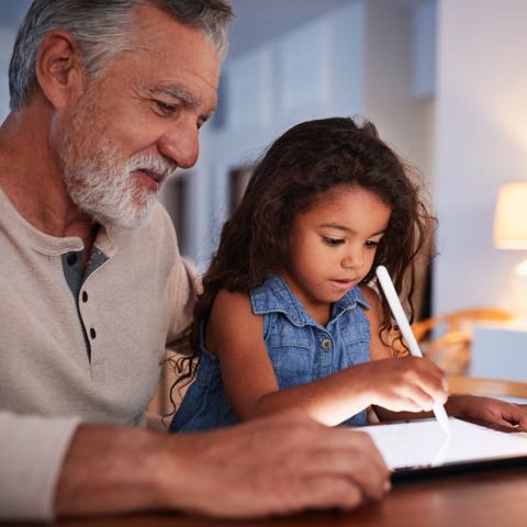 Grandfather drawing with his granddaughter