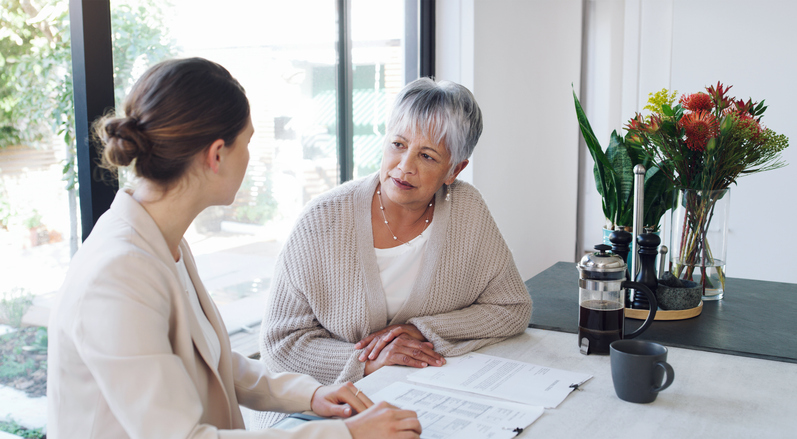 Older woman going over details of her will with lawyer