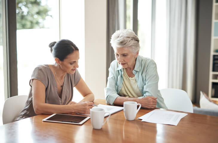 Older woman looking over her estate plan with attorney