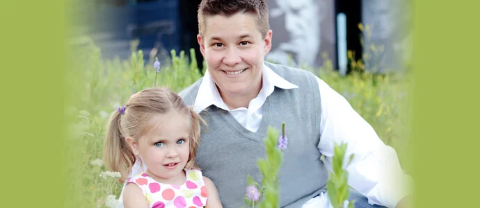 Chris Tymchuck and her toddler daughter holding a flower