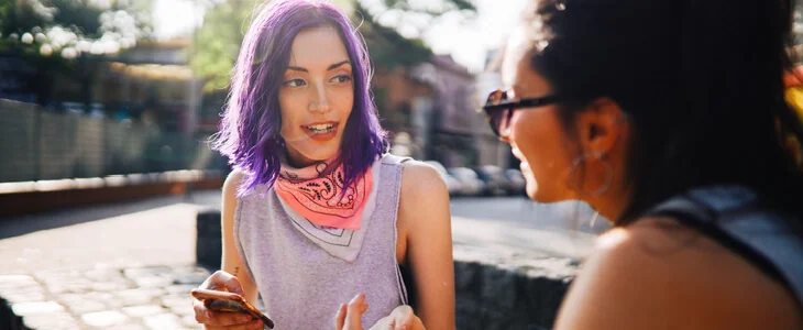 two LGBTQ women talking at the park