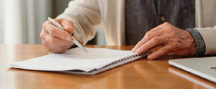 Elderly man writing a will