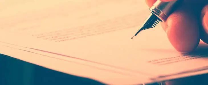 Young man signing a will