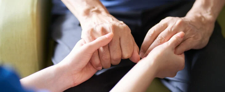 Hands of caregivers and the elderly