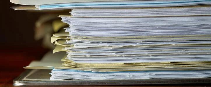 File folder on a desk with financial documents inside