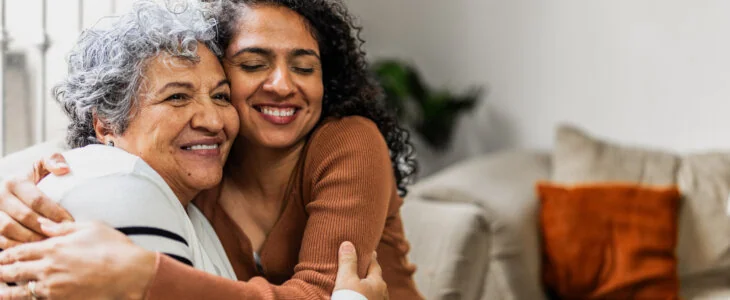 Mother and daughter embraced at home